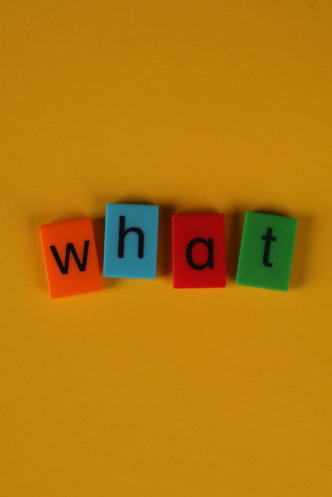 pexels-photo-32392305-32392305 Colorful letter blocks spelling 'what' on yellow background, great for educational and creative content.